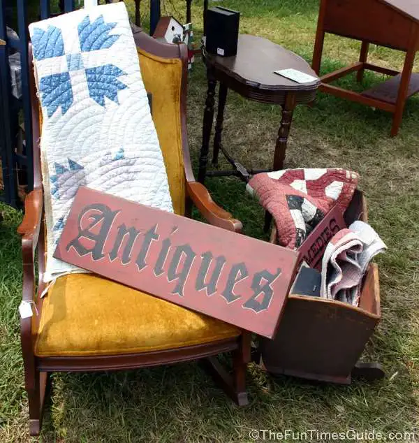 I love the "homey" feel here with the antiques sign placed on antique furniture at a yard sale.