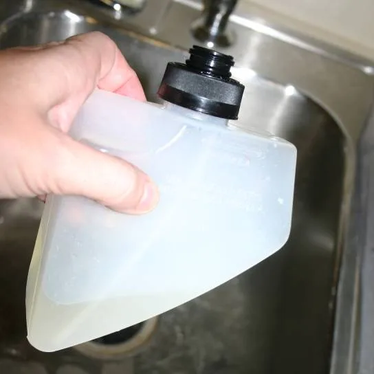 A closeup of the Bissell Proheat carpet cleaner's removable soap container. (It's super EASY to fill!)