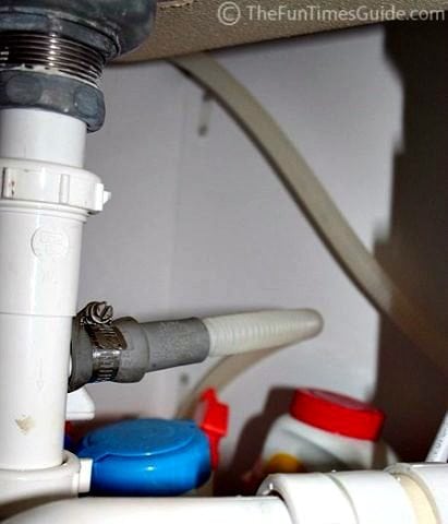 A look under our sink where the drain hose from the dishwasher is... with hose clamps..