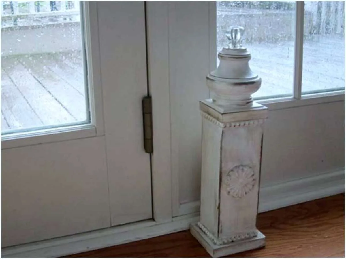 A rustic post used as a DIY door stop. Make your own using this tutorial from Momtastic, or use any ceramic/terracotta post or statue that you already have.