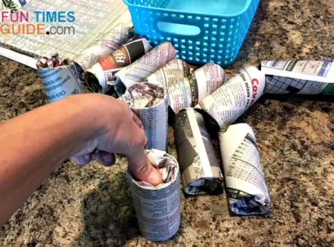 Stuff the excess newspaper into both ends of each cardboard tube.