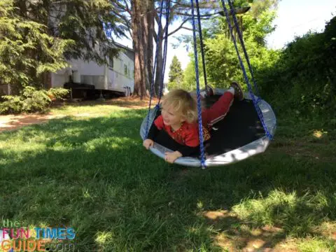 This DIY tree swing hangs from a tree in our backyard. My son loves his new saucer swing! 