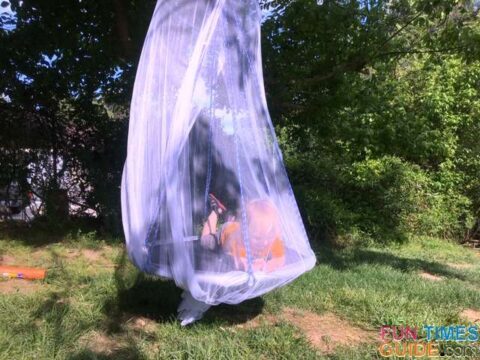 I added a bed canopy to our DIY tree swing for a cabana-like feel. The canopy is easy to put on and take off. photo by Candida at TheFunTimesGuide.com