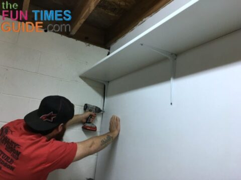 My husband hanging the shelf mounting brackets in our garage.