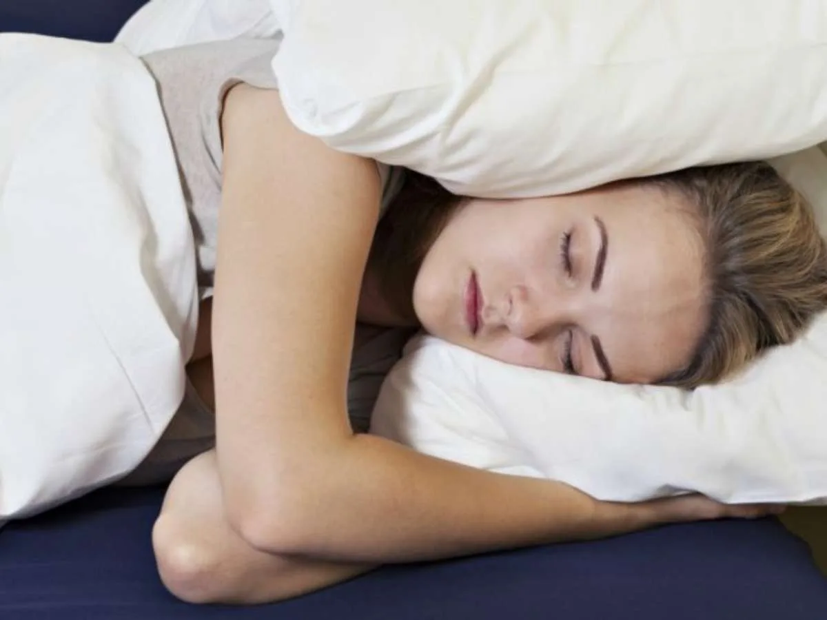 I've found that you can drown out noise while you sleep simply by placing a down pillow over each ear while sleeping on your side.