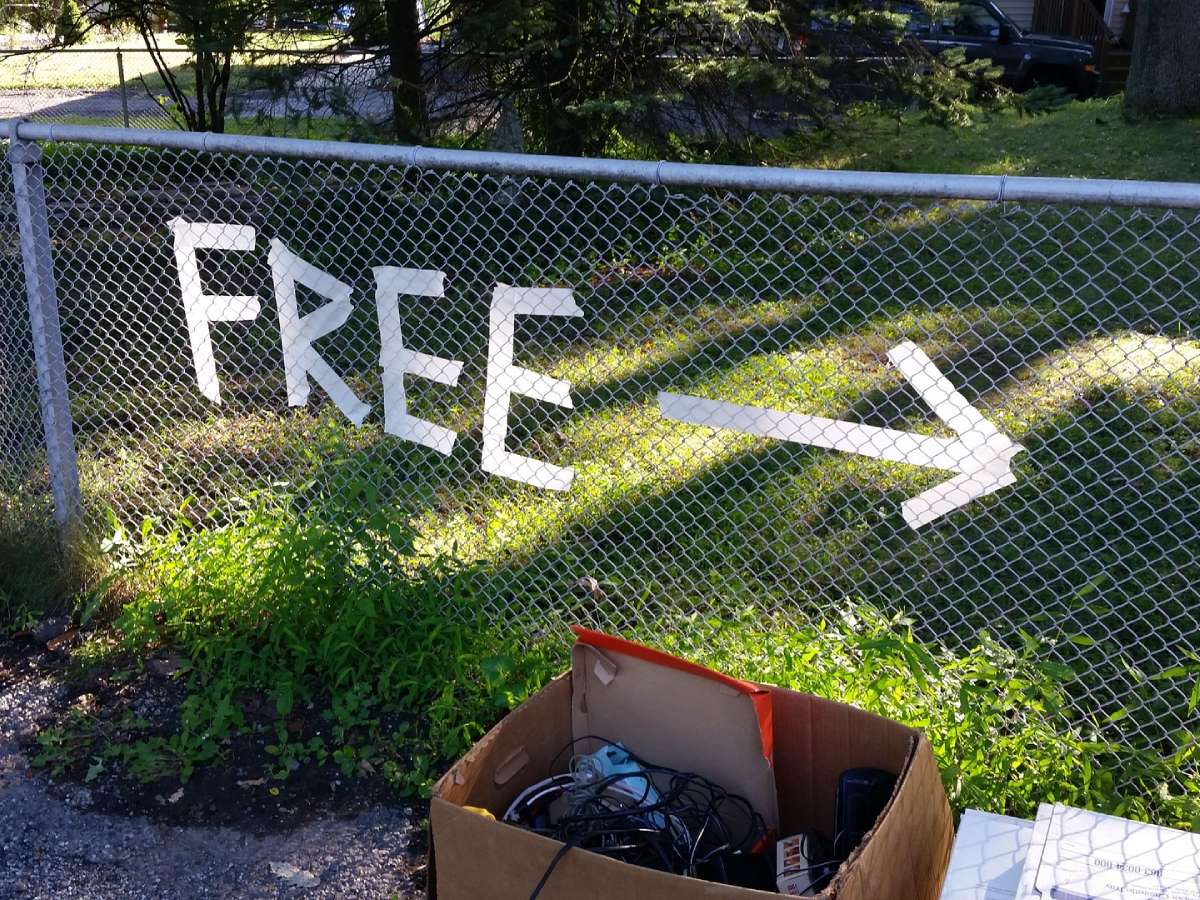 Have a fence near your driveway? You could USE TAPE to "make" a sign on the actual fence - as seen in this photo. Or, simply attach a "regular" yard sale sign to the fence to attract attention. (A fence sign would be higher than a yard sign -- making it easier to see.) 