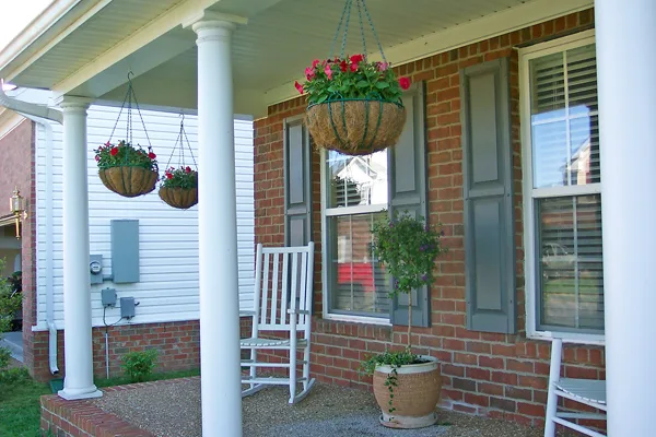 My hanging flower baskets on the front porch filled with red impatiens.
