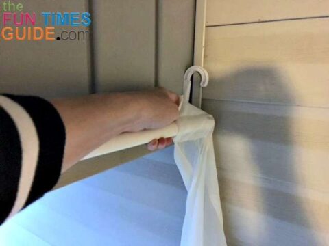installing-porch-curtains The last step is to add the sheer curtain panels onto your DIY pvc pipe curtain rods.