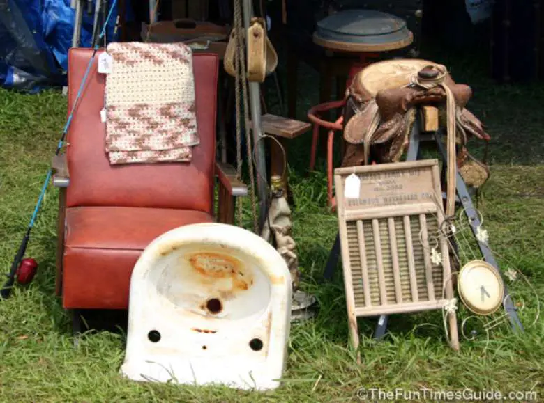 Large antique furniture items for sale at a yard sale placed up close to the street. 