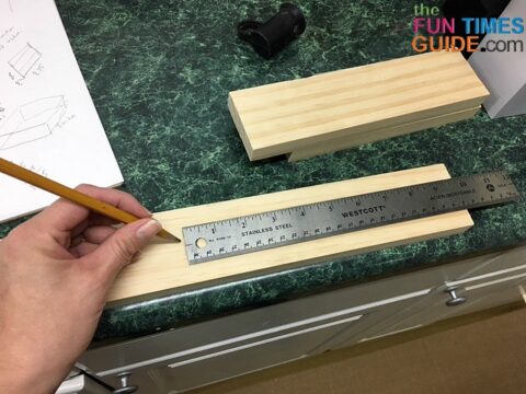 Measuring for cuts on the pine board.