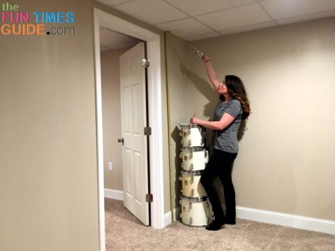 Taking measurements from floor to ceiling.