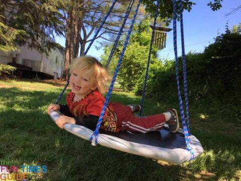 As you can see, my son absolutely LOVES his new trampoline swing! photo by Candida at TheFunTimesGuide.com