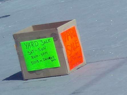 An example of how to use a cardboard box as a sturdy sign holder for your eye-catching yard sale signs.