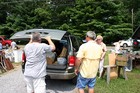 A van overloaded with bargains and yard sale finds.