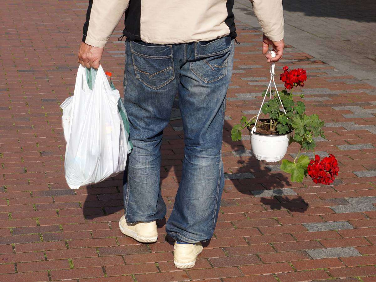 This is an example of using plastic grocery bags for people to carry things they've purchased at your yard sale. (And yes... I've given and sold flowers at my garage sales before!)