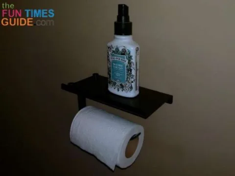 This toilet paper shelf is perfect for holding a bottle of Poo Pourri toilet spray in the guest bathroom!