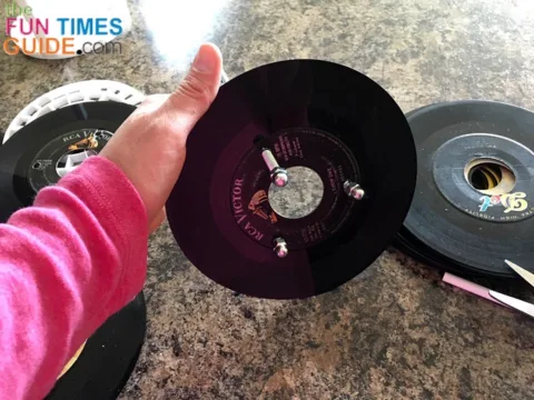 Then I pushed the 3 steel rods through the 3 holes in the first vinyl record.