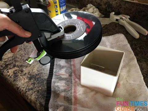 I used a spare piece of leftover vinyl fence post that we had lying around. to drill through the vinyl records without damaging the countertop.
